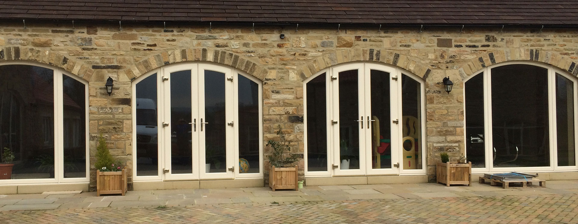 Barn conversion with arched white French doors