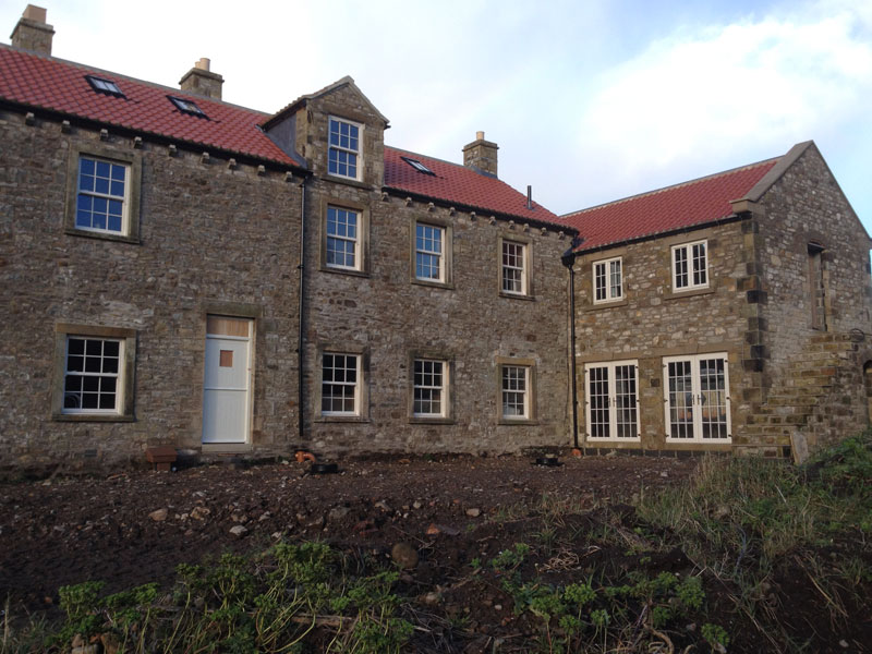 Stone houses fitted with new white windows and doors
