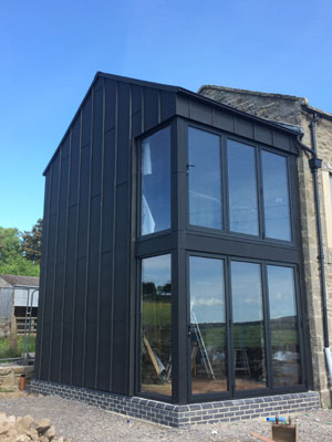 Modern glazed extension with dark grey frames